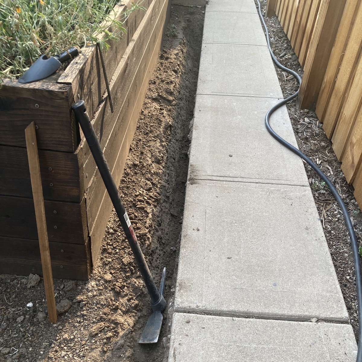 The trench passing a raised garden bed
